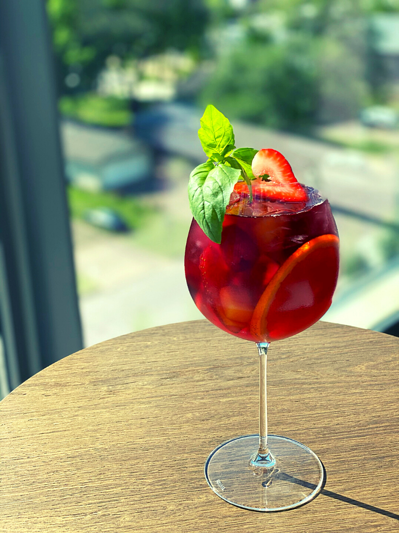 Glass of sangria sitting on wooden table