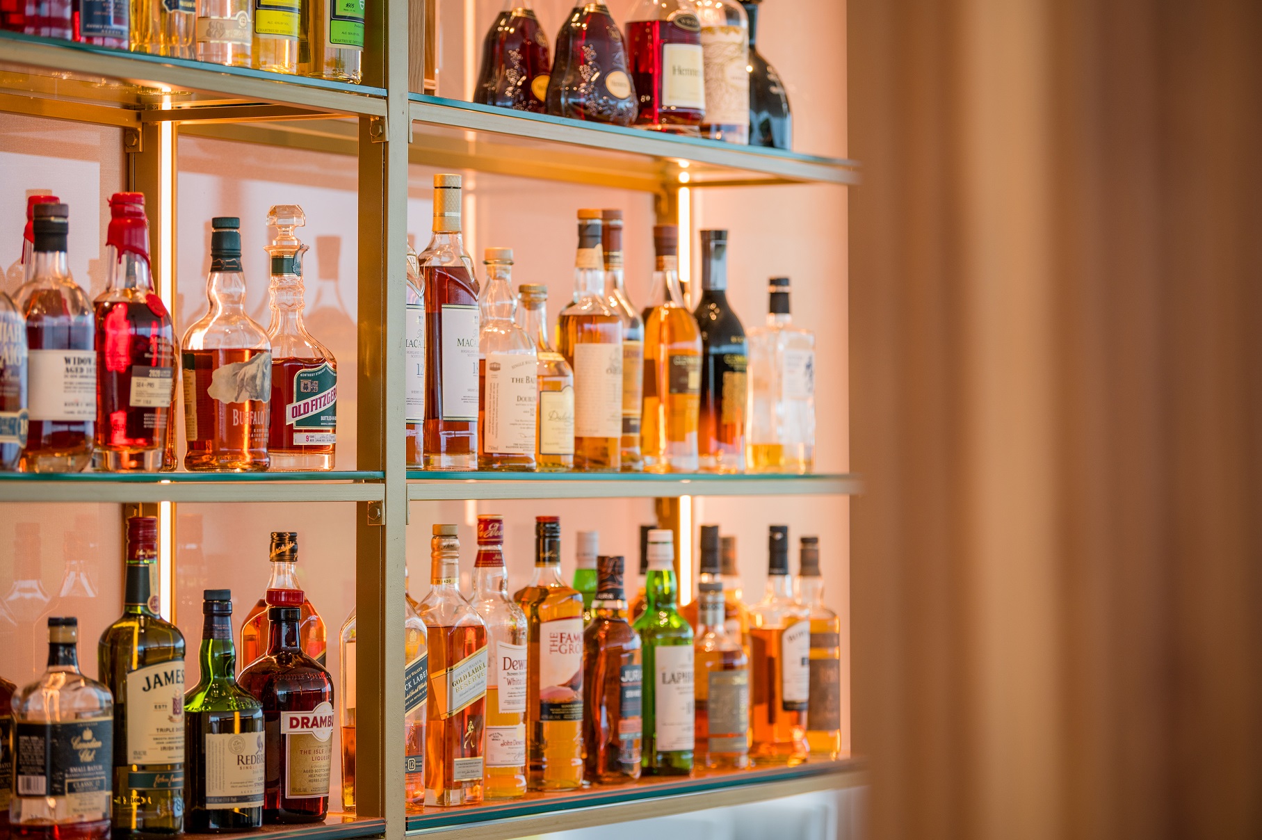 Multiple shelves of alcohol bottles