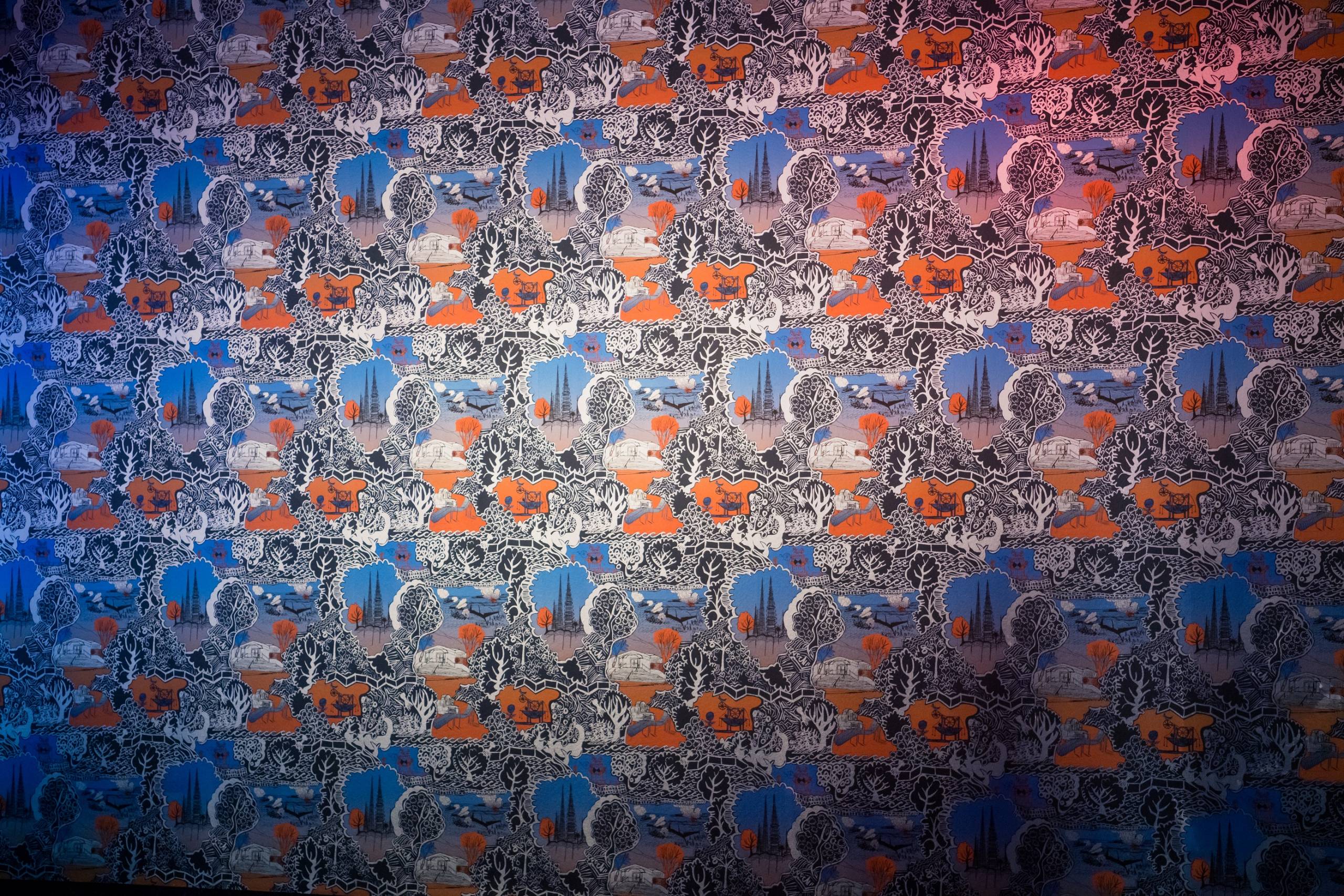 Wallpaper with an elaborate print in blue and orange