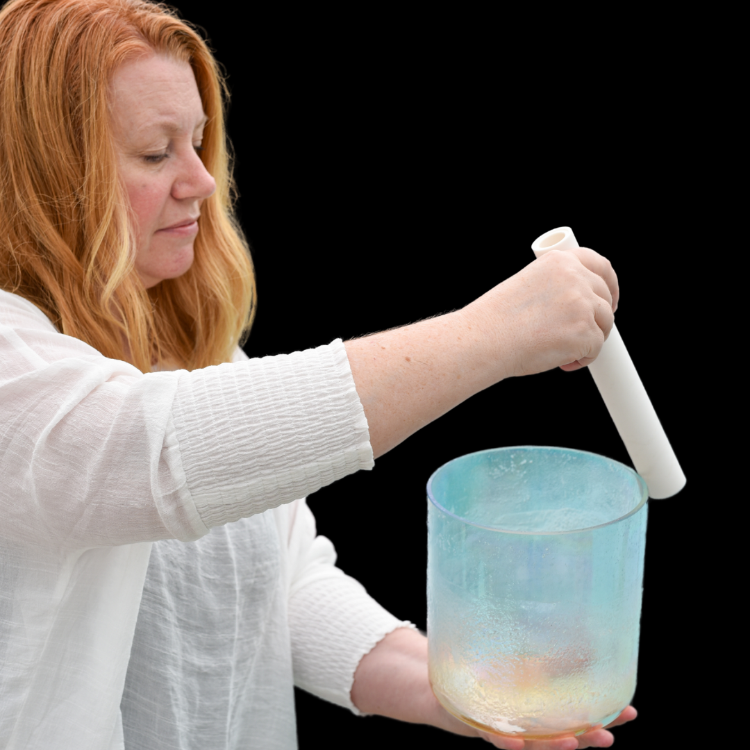 Instructor Tammy Mores ringing a crystal bowl as part of a sound bath practice
