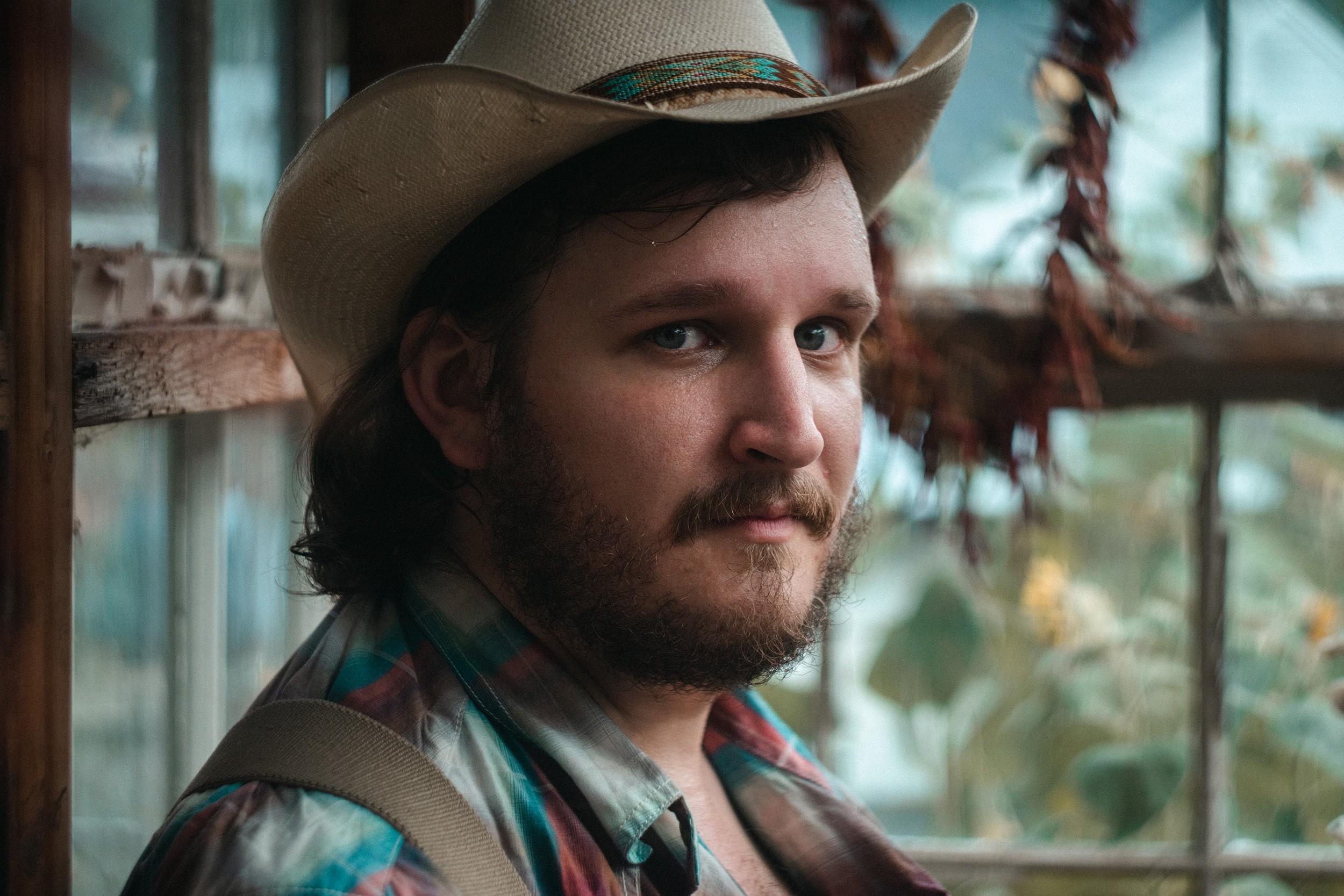 Headshot of man wearing a cowboy hat