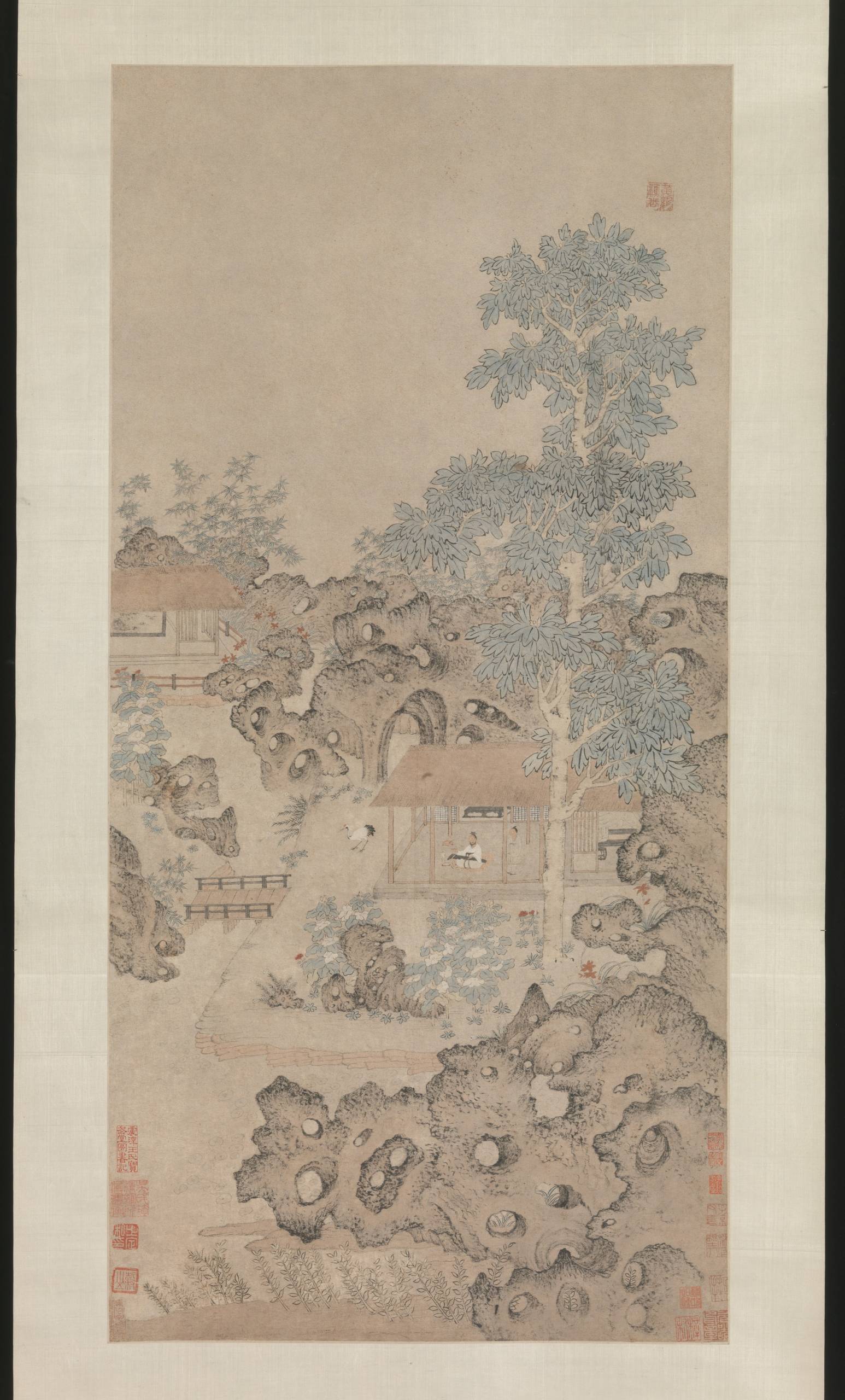 a sixteenth-century Chinese painting that depicts a man sitting in a house playing a synth for his pet crane underneath a large paulownia tree