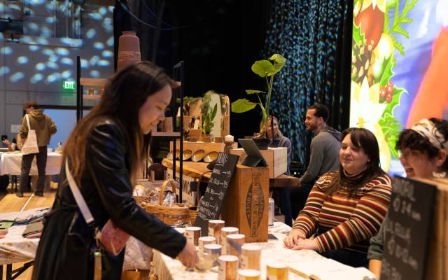 A woman shops at the indoor Holiday Market at the Momentary