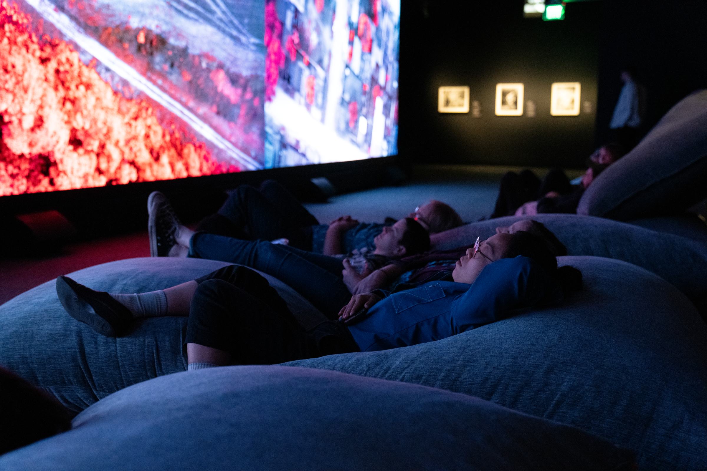 Broken Spectre Viewing Guests lying on beanbag cushions watching a large LED screen playing Broken Spectre