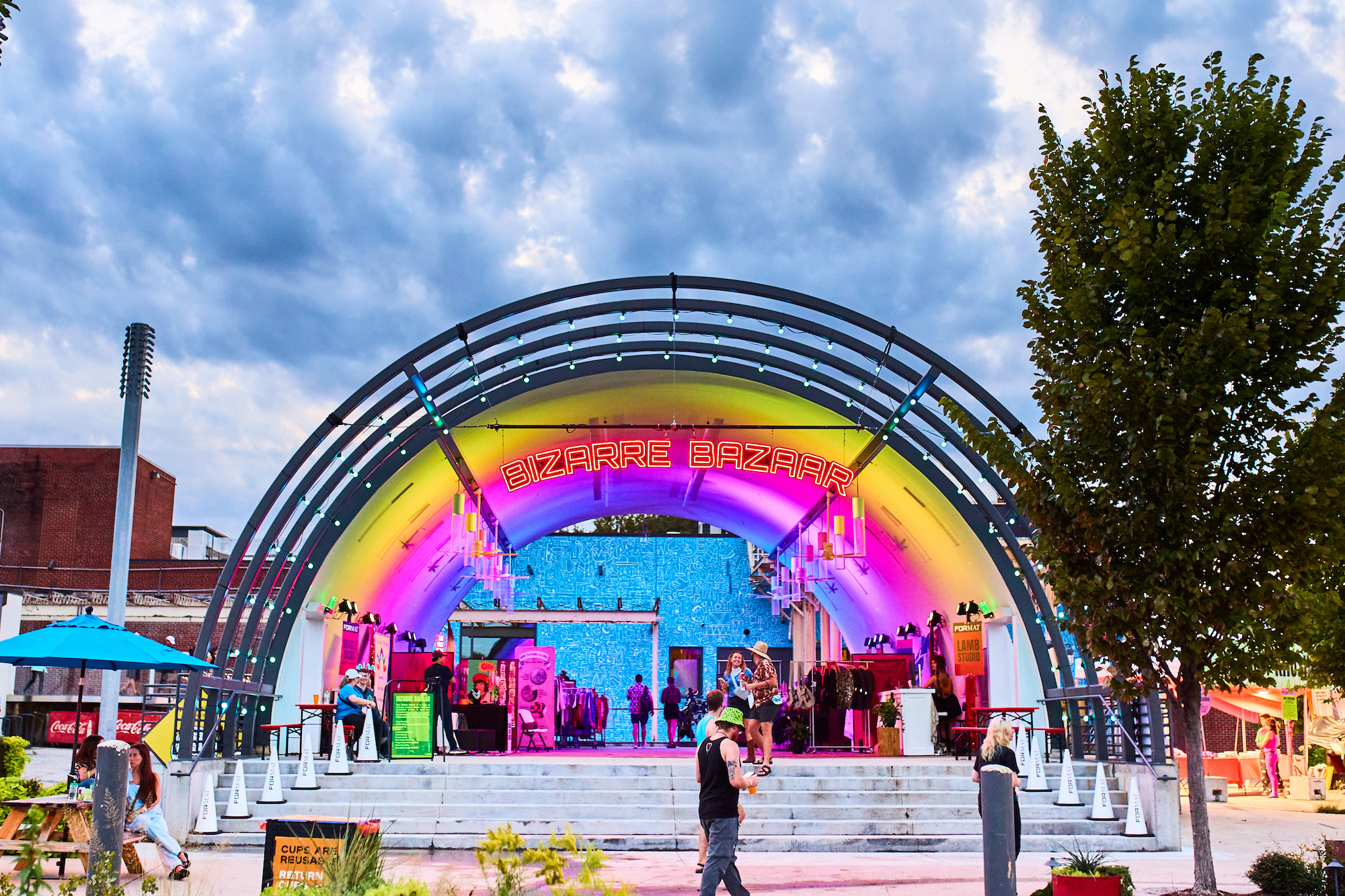 Quonset Hut with colorful lights projected on ceiling and booths inside.