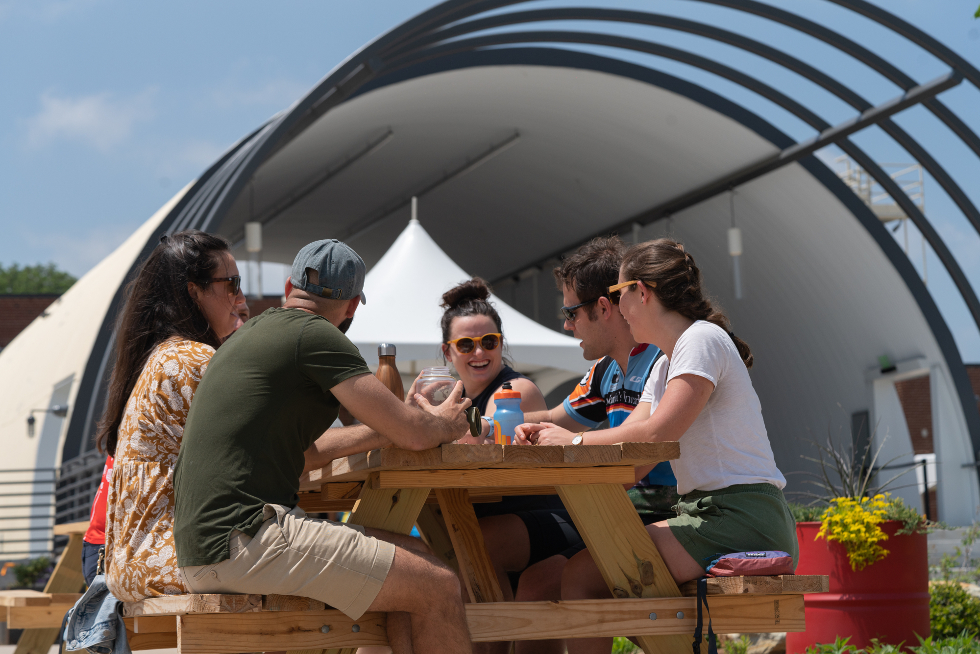 People sitting at picnic table eating