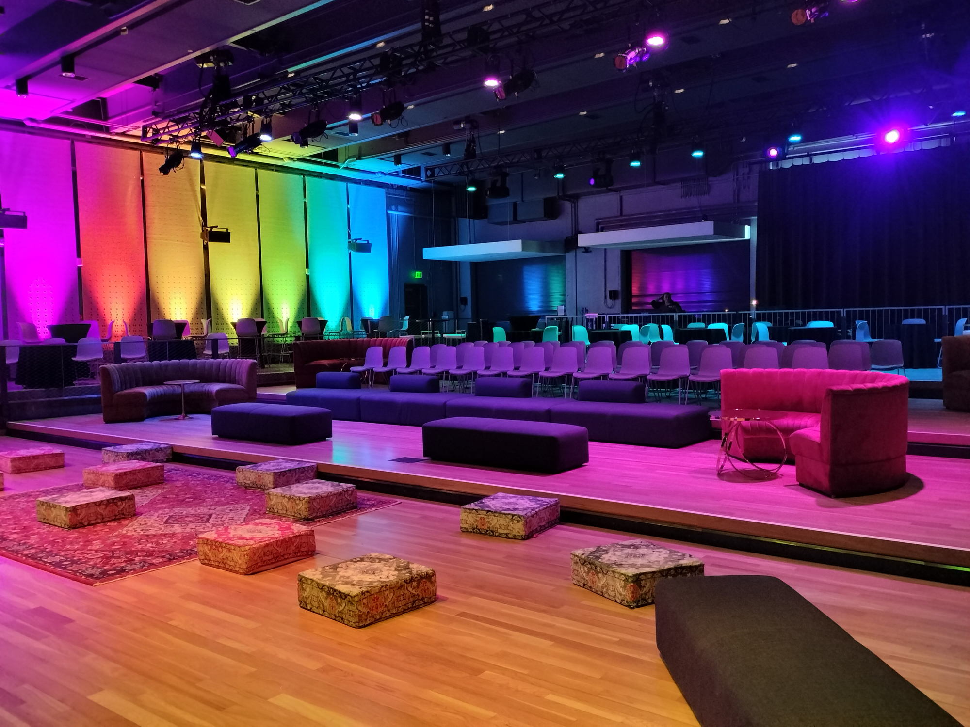 Røde House Room set up for casual presentation with mix of chairs, benches, and floor pillows