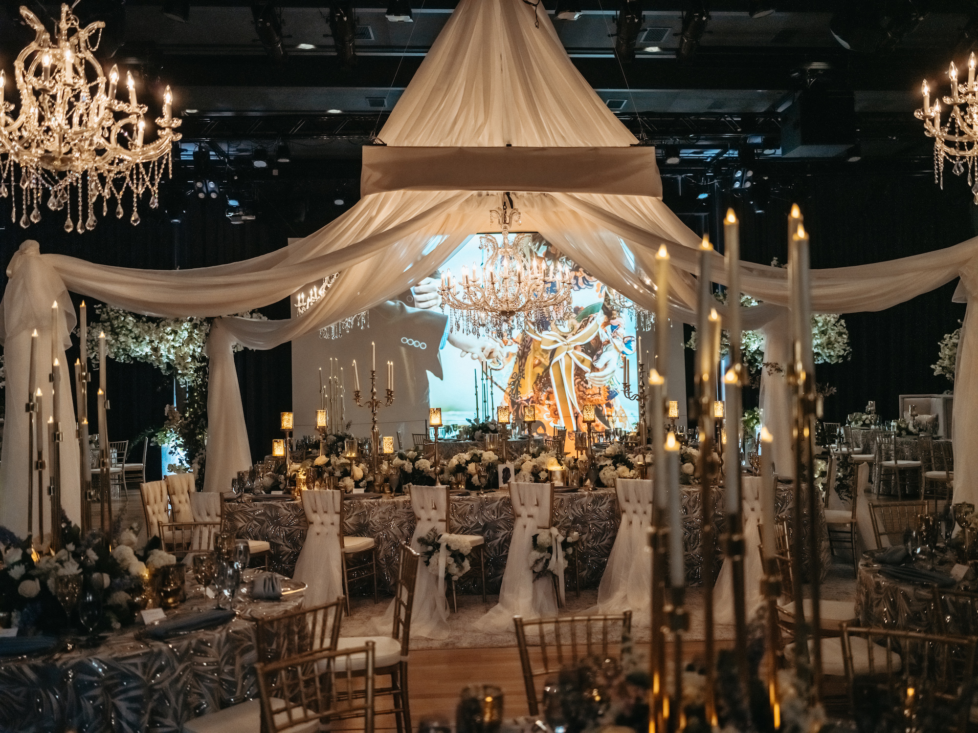 Room decorated in white for a special event with tables and chairs