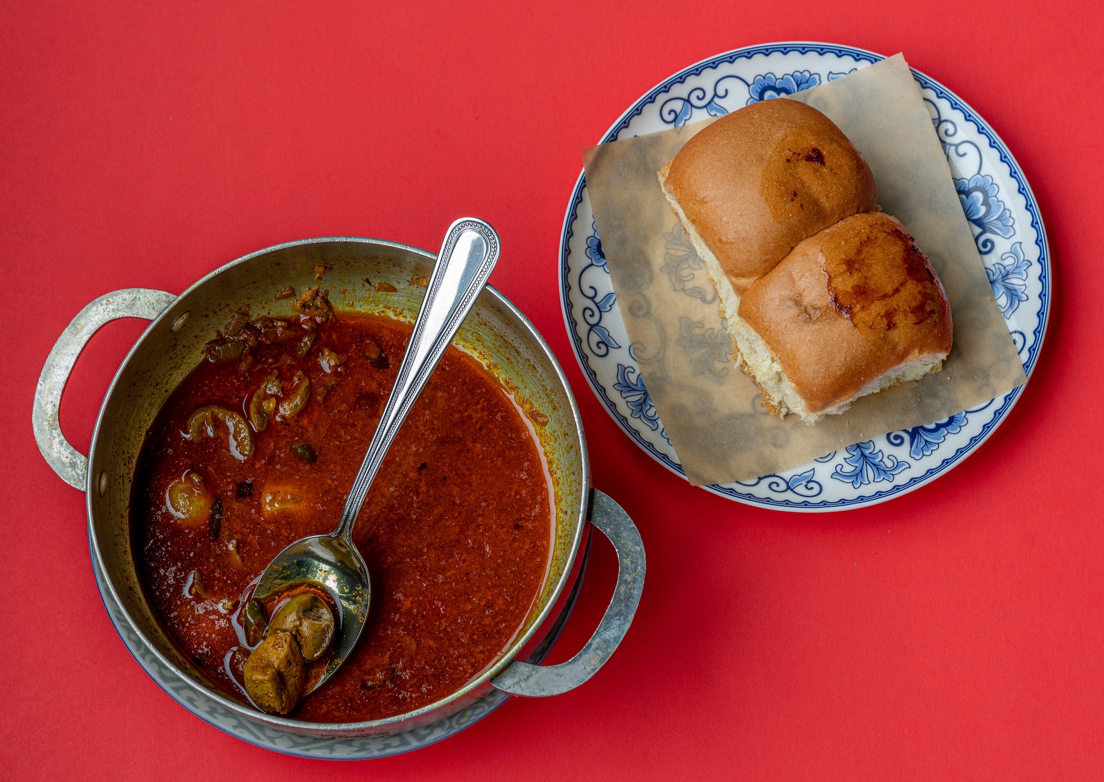 Two dishes next to each other. One has a spoon containing the Gurda Kapoora dish from Dhamaka, accompanied