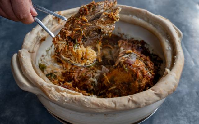 White ceramic bowl dish containing the Nalli Biriyani food dish from restaurant Dhamaka.