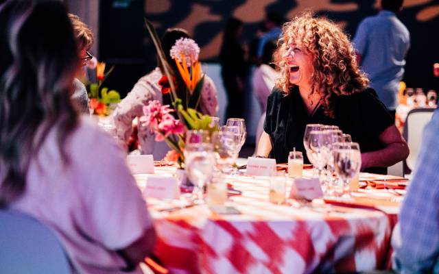 People sitting at a table laughing and socializing