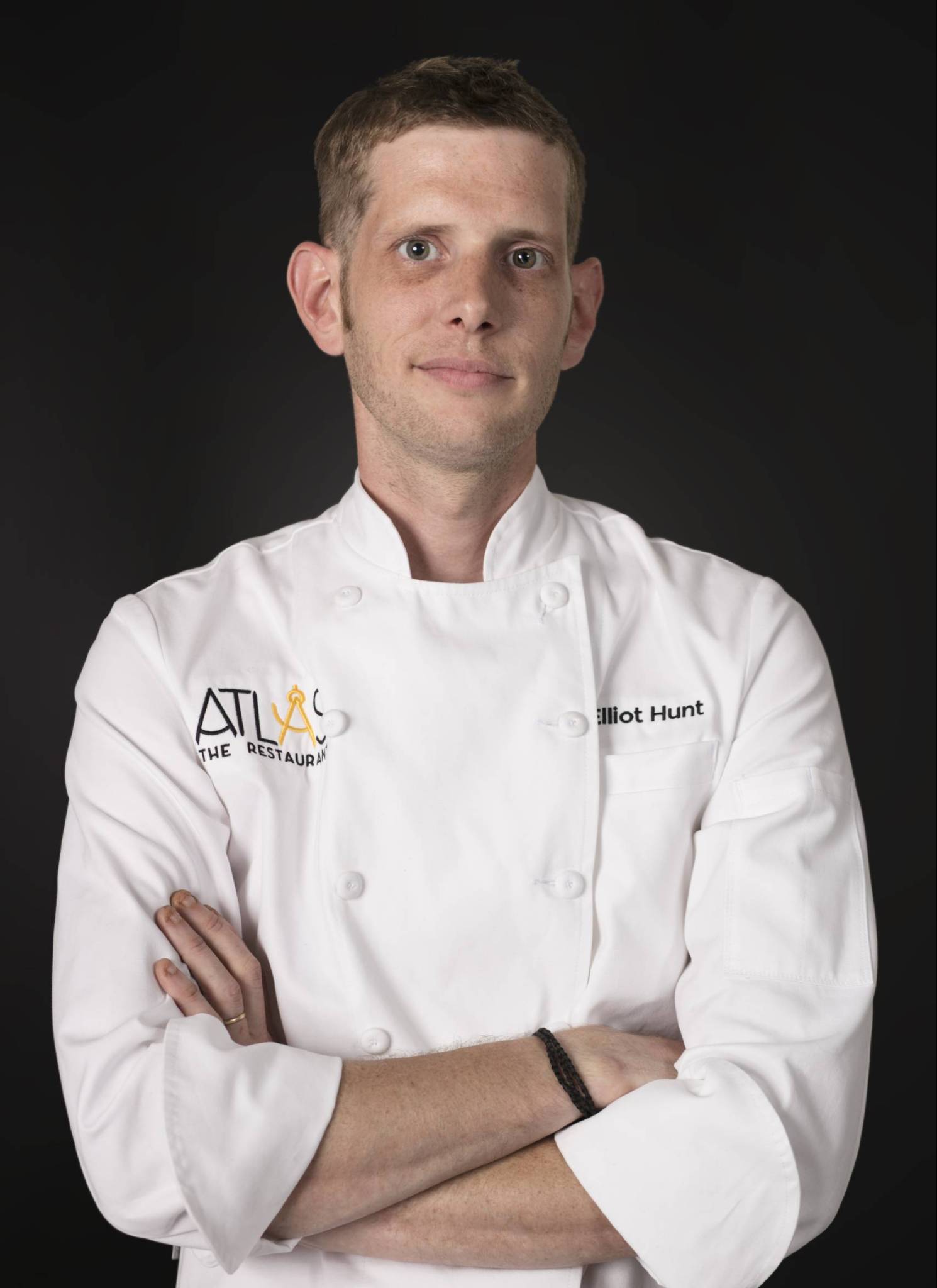 Chef Elliot Hunt in white coat with 