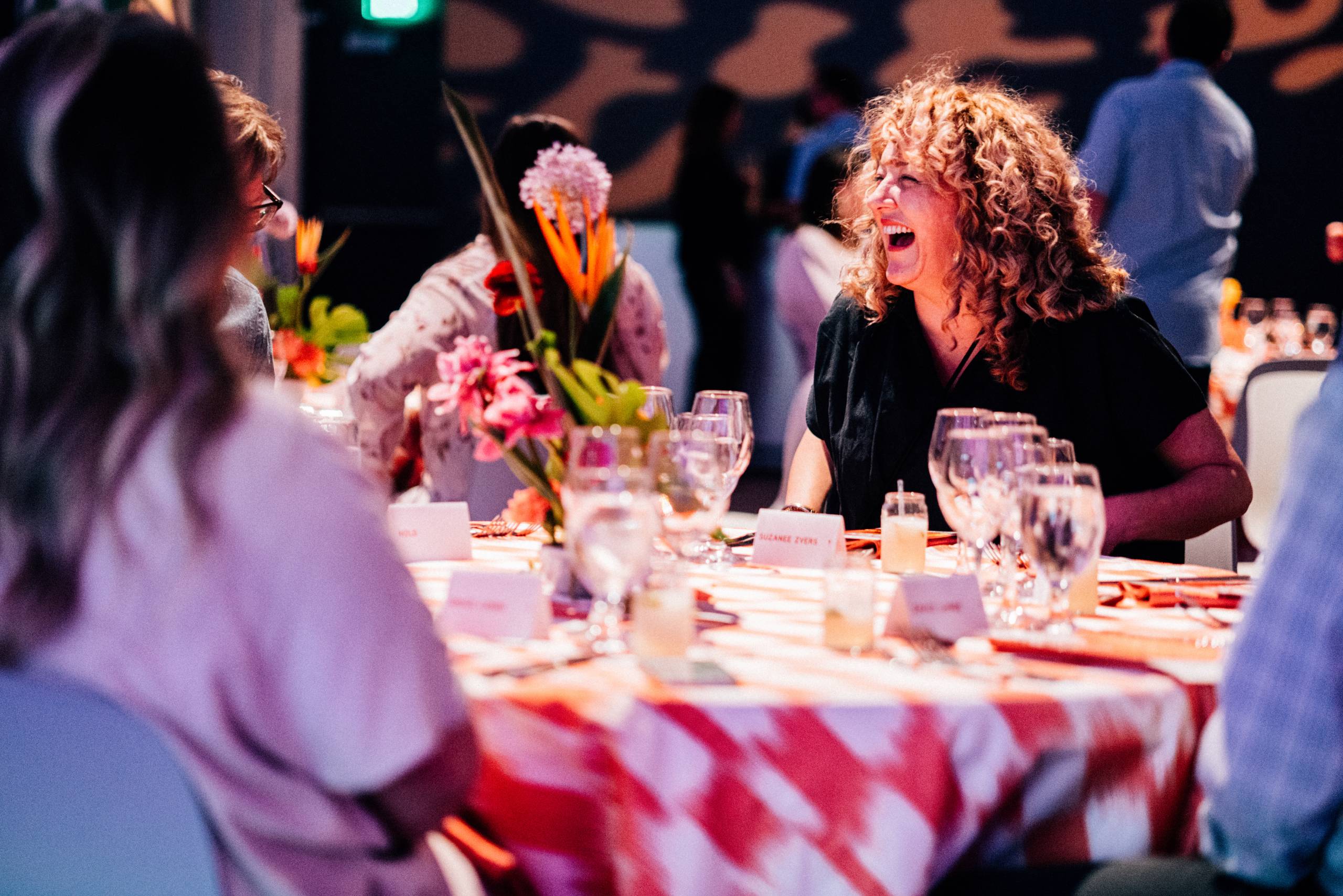 People sitting at a table laughing and socializing