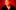 Person in black zip-up jacket with motion-blurred face against a red background