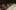People sat applauding down a long white table lit by candles