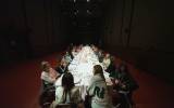 People gathered around a long white table