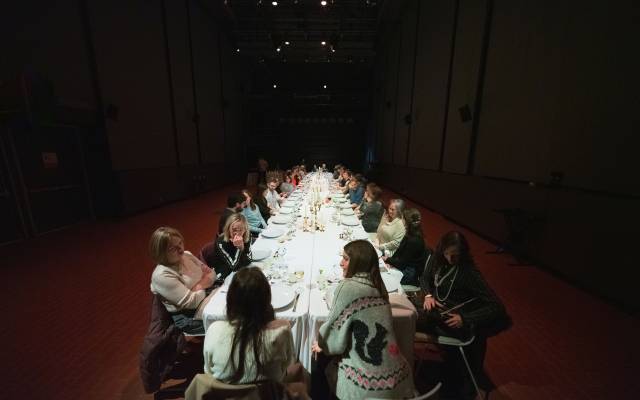 People gathered around a long white table