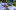 HSHS hand image Person using DJ equipment and laptop outdoors with microphone and greenery in background.