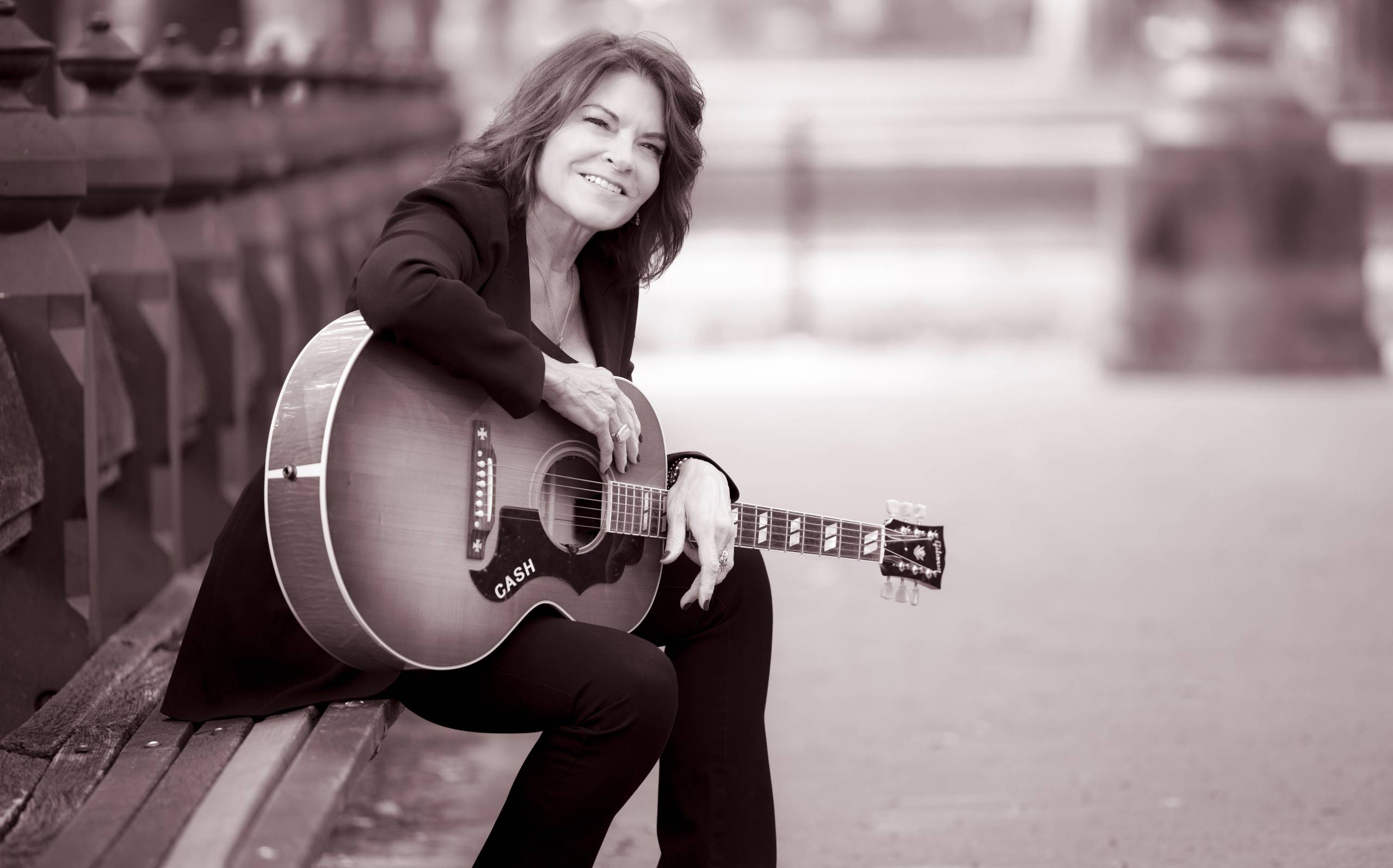 TC_guitar photo credit Pamela Springsteen Person on bench holding