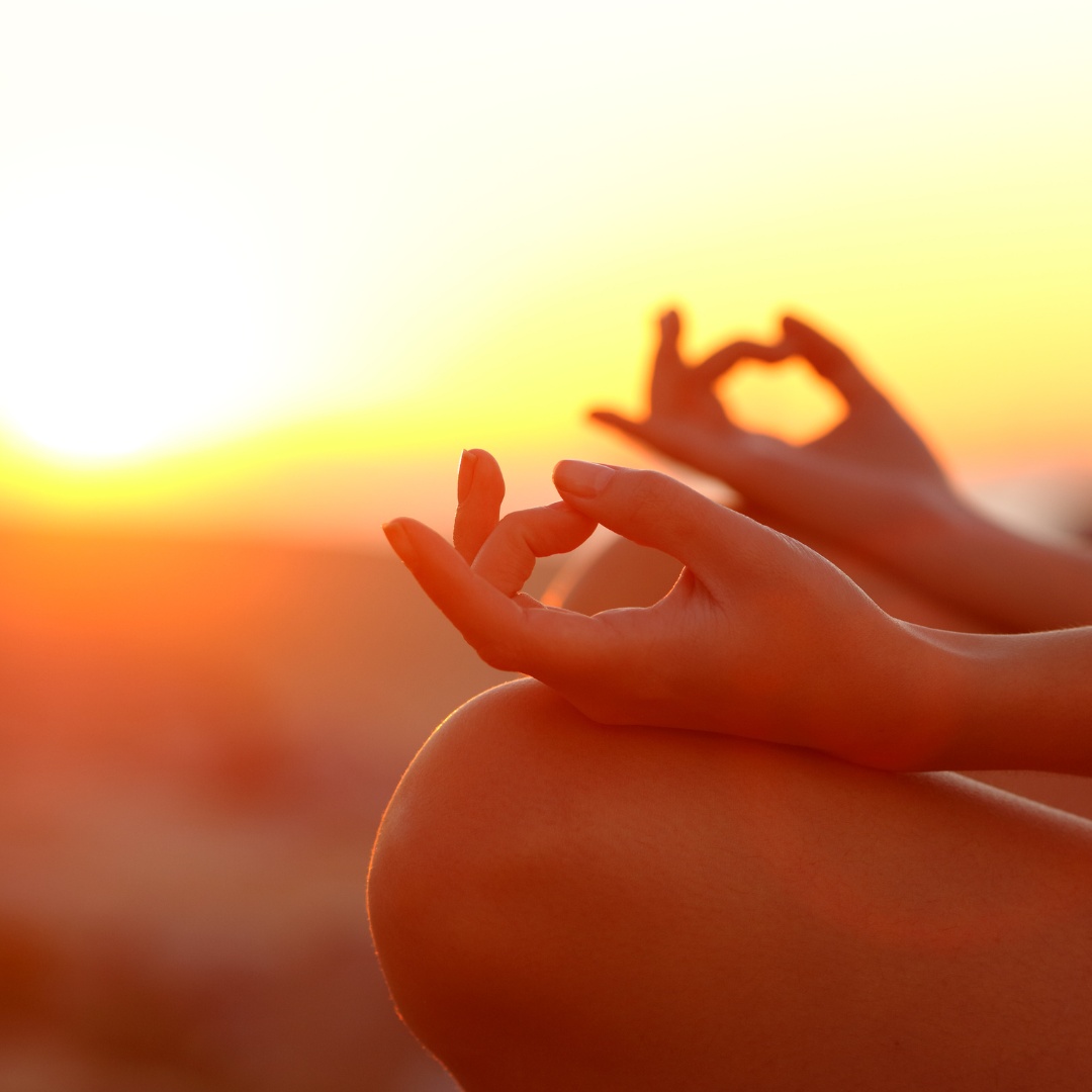 July _ Summer Radiance - Flow & Glow Person meditating outdoors at sunset with hands in meditation mudra, warm glow in background.