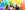 Photo by Ironside Photography / Stephen Ironside. Four people embrace under a rainbow balloon arch with trees and urban background.