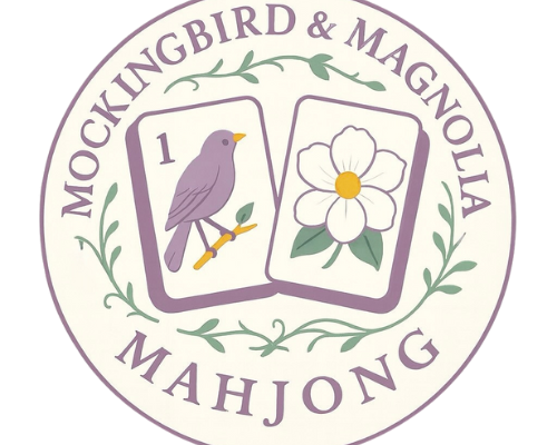 Logo showing two Mahjong tiles with a purple mockingbird and a white magnolia flower, surrounded by text and green vines.