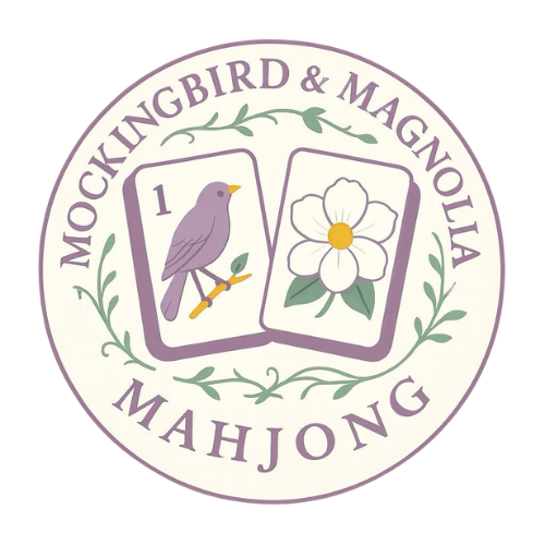Logo showing two Mahjong tiles with a purple mockingbird and a white magnolia flower, surrounded by text and green vines.