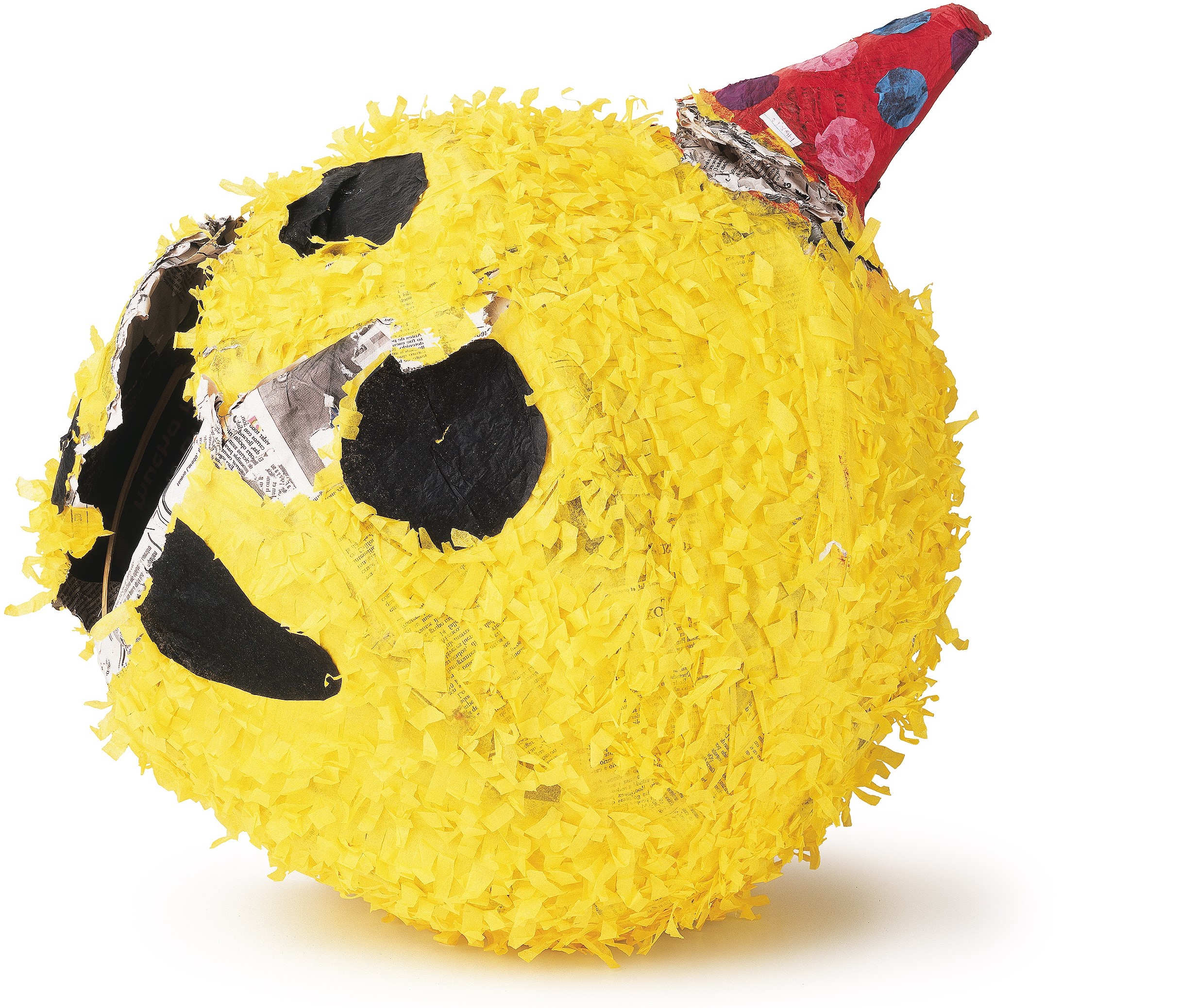 Yellow piñata with a smiling face and a red party hat with colorful polka dots.